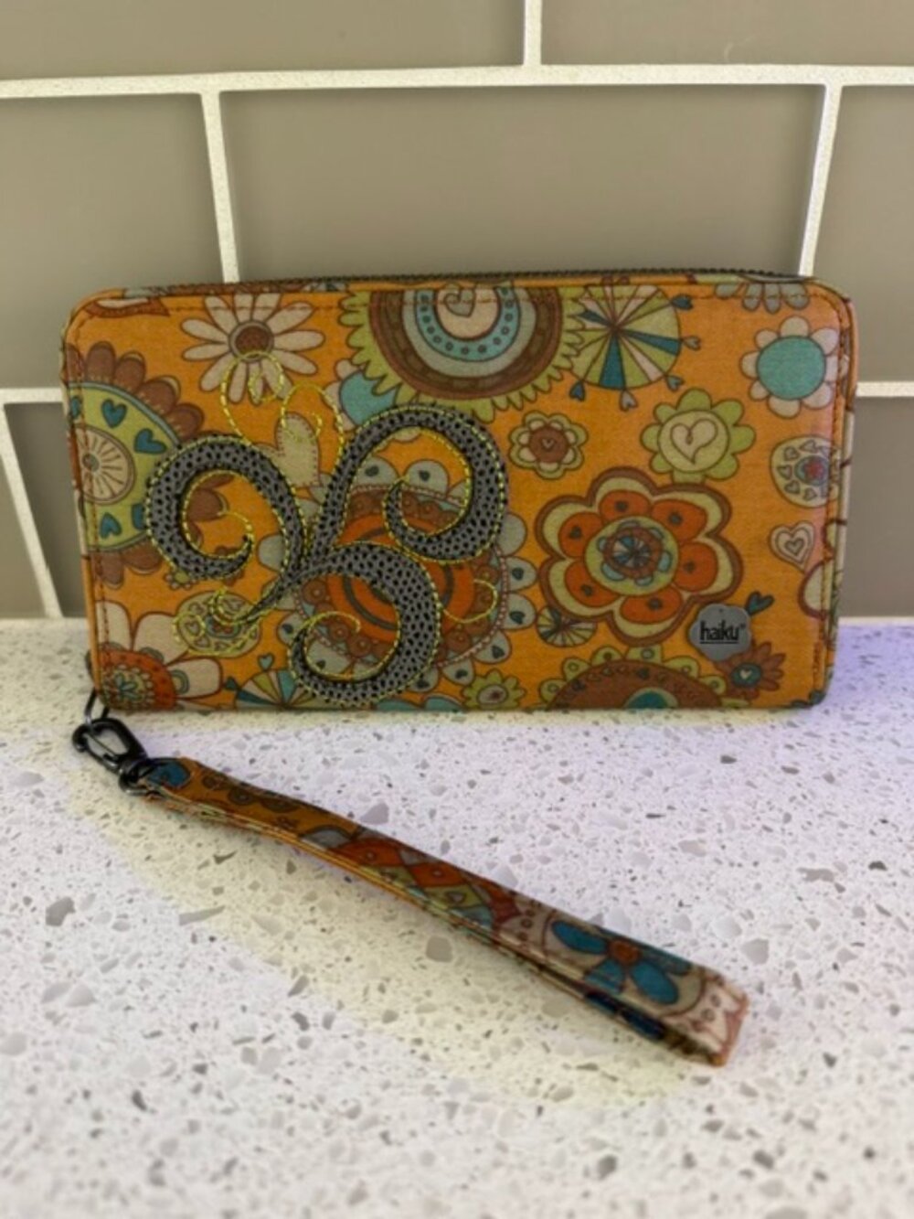 Haiku Black Vinyl Wristlet/Wallet with Intricate 70s-Inspired Psychedelic Floral